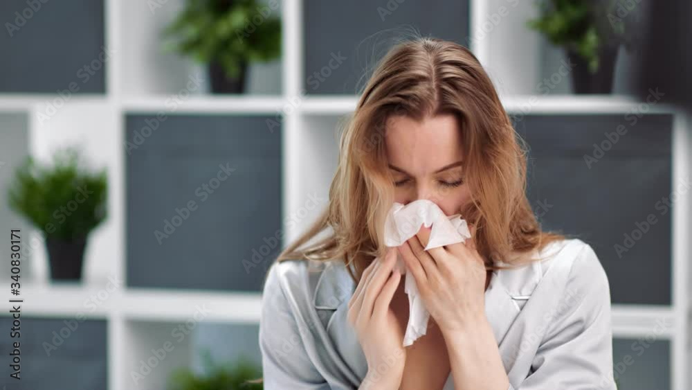 Illness woman with virus infection coughing and sneezing. Medium close up shot on 4k RED camera Illness woman with virus infection coughing and sneezing. Medium close up shot on 4k RED camera