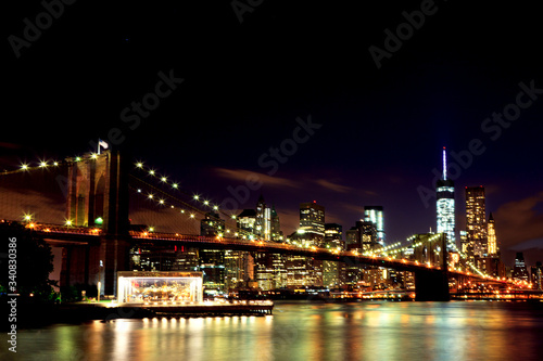 New York  Lower Manhattan through Brooklyn Bridge in night