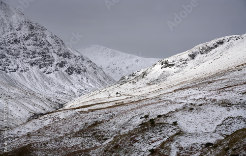 Snow and ice covered mountain ridges in the Lake District on a cold winters day. In the distance is Lower Man, Kepple Cove and Catstye Cam on the left.