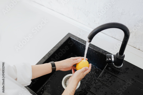 Woman washing a lemon