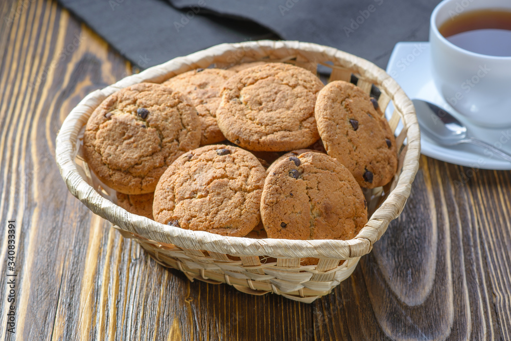 oatmeal cookies with chocolate chips in a basket on a wooden table oatmeal cookies with chocolate chips in a basket on a wooden table