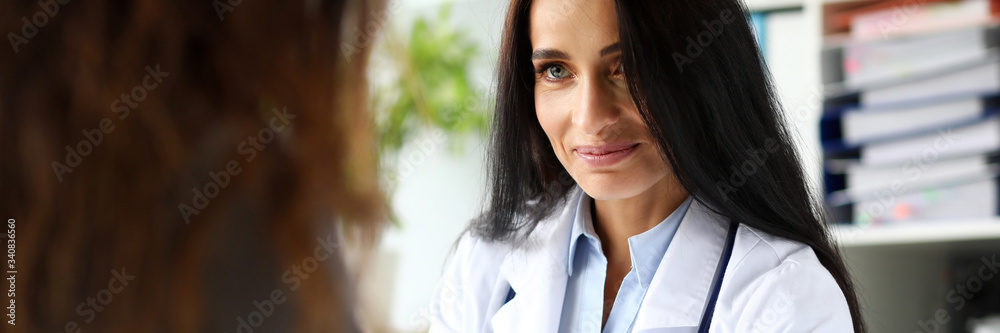 Beautiful caucasian GP touching visitor hand telling great news portrait Beautiful caucasian GP touching visitor hand telling great news portrait