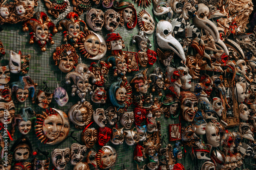 Venetian masks for carnivals on the wall in the store | VENICE, ITALY - 16 SEPTEMBER 2018. 