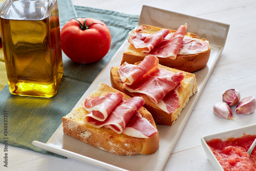 Mediterranean breakfast, spanish breakfast, toast whith olive oil, tomato and iberiann ham.