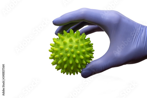 Hand in a blue medical glove with an abstract green virus isolated on white