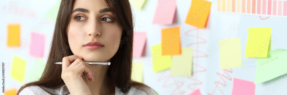 Pretty female clerk standing in office solving difficult task headshot Pretty female clerk standing in office solving difficult task headshot