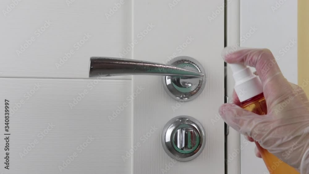 Concept of disinfecting surfaces from bacteria or viruses sill-life, hand cleaning door handle with disinfectant. Coronavirus, covid-19 protection Concept of disinfecting surfaces from bacteria or viruses sill-life, hand cleaning door handle with disinfectant. Coronavirus, covid-19 protection