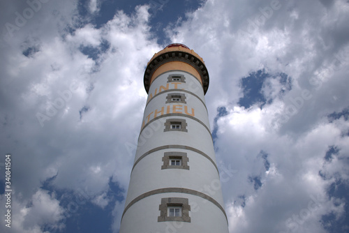 closeup of lighthouse with cloudy sky inbackground photo