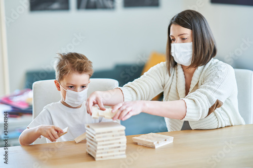 Mother and child playing together at home isolation during coronavirus pandemic