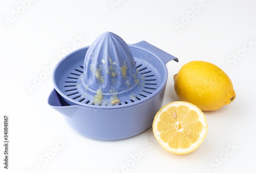 lemons and juicer prepared for use on white background