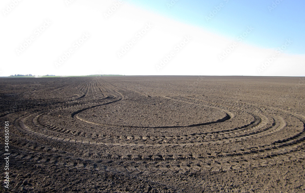 Plowed field for potato in brown soil on open countryside nature