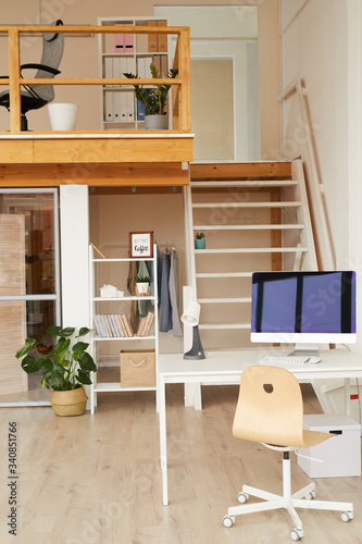 Fototapeta Naklejka Na Ścianę i Meble -  Vertical background image of contemporary two level office space with computer desk in foreground, copy space