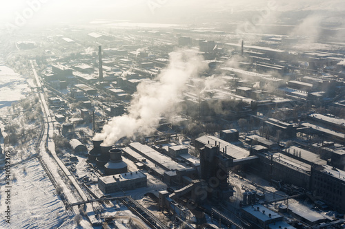 Aerial view of factory with smoking chimneys