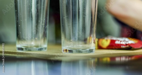 imelapse in a dark cafe, bar, dining room, restaurant, eating, mood, reflection in glasses, wine glasses, glass, utensils. photo