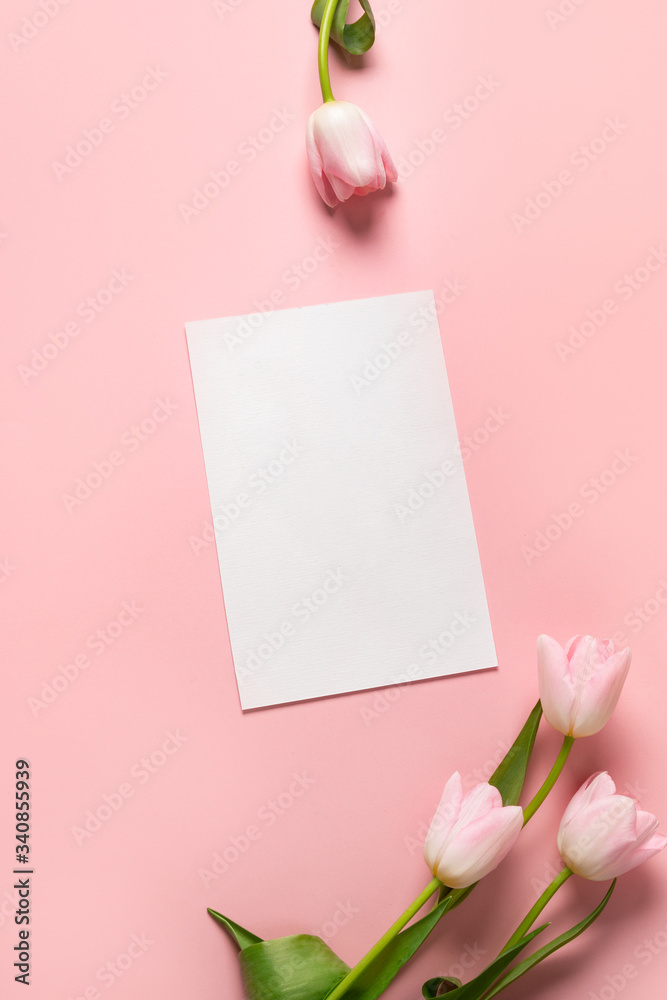 Pink tulips and empty greeting card for cheers on pastel pink. Top view with copy space. Mother Day. Pink tulips and empty greeting card for cheers on pastel pink. Top view with copy space. Mother Day.