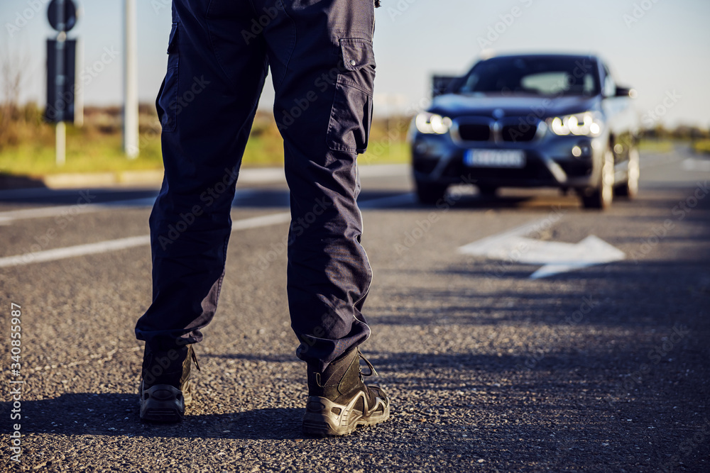 Police officer stops the car on the road. Police officer stops the car on the road.