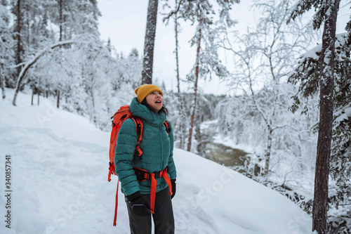 Woman trekking through a snow covered Lapland, Finland