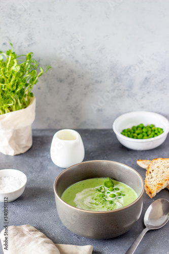 Green pea soup on a gray background. Healthy eating. Vegetarian food. Recipe. Diet.