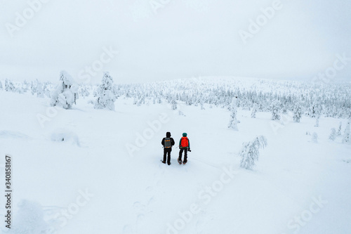 Drone shot of landscape photographers trekking in Lapland, Finland