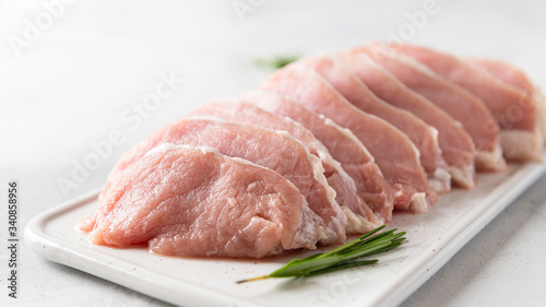 Fresh meat with spieces for cooking on white background, side view, close up. Cooking, raw ingredients