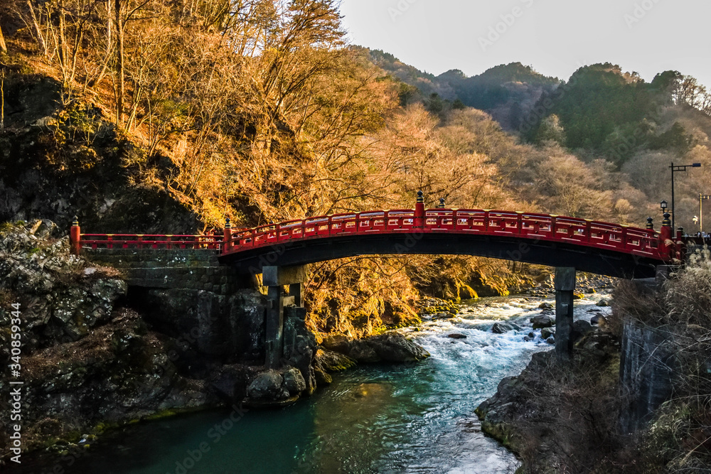 Fototapeta premium Distinctive red wooden bridge in the mountain small town Nikko in japan
