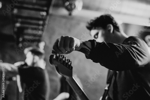 Man on the stage tuning his guitar
