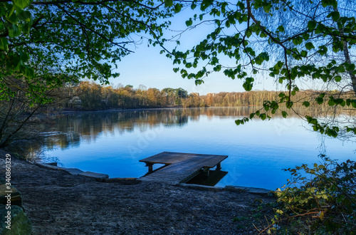 Ufer mit Holzsteg an einem See in Duisburg photo