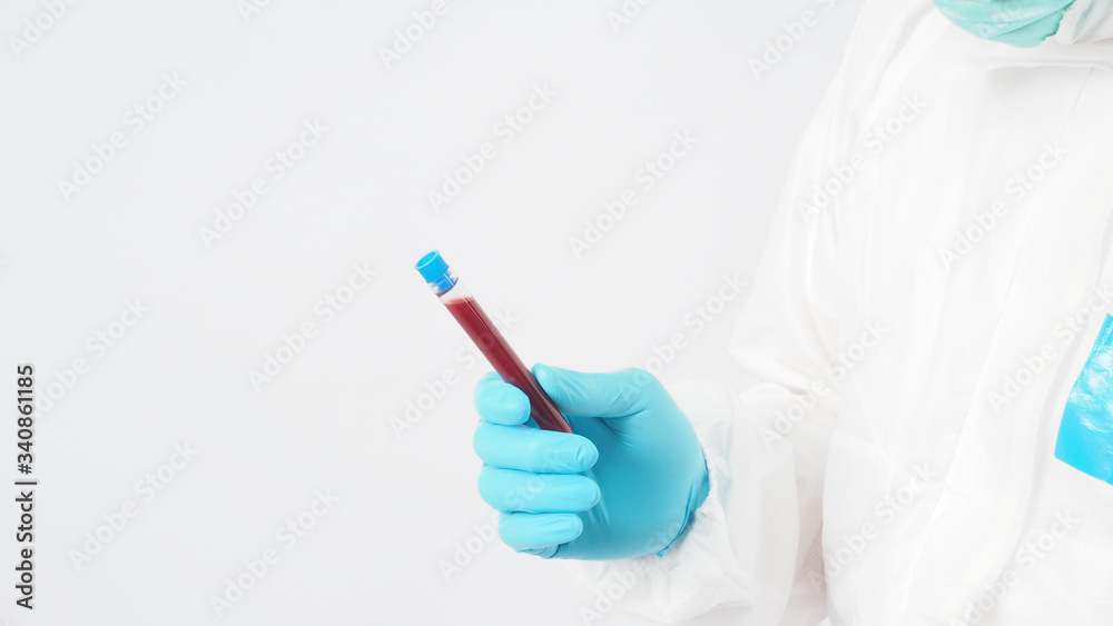 Male model with PPE suite and Hand with glove is holding blood collection tube on white background. Male model with PPE suite and Hand with glove is holding blood collection tube on white background.