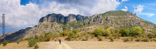 Panorama of the mountain slopes with rocky cliffs in fall