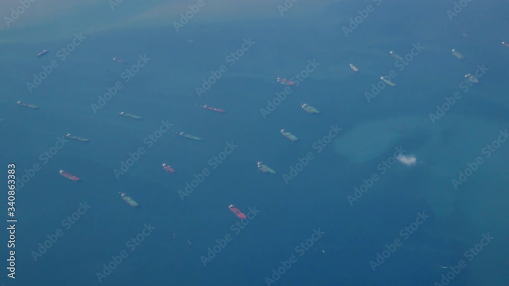 custom made wallpaper toronto digitalThe view from the plane window is flying over the ocean. Many ships, cargo ships or oil vessels are sailing in the sea to wait to dock in transportation concept aerial view shot in 4K resolution.