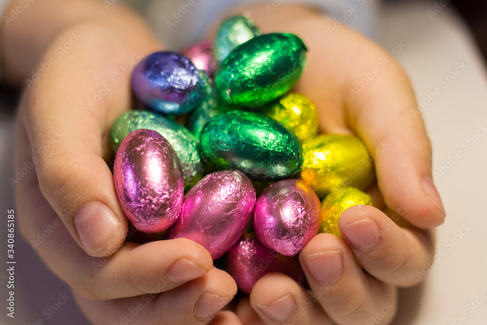 Chocolate eggs in the hands of a child Chocolate eggs in the hands of a child