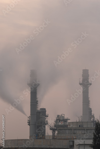Power plant on sunrise sky. Chimney of thermal power plants. Gas turbine electrical power plant at industrial Estate.