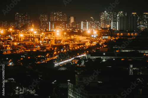 Urban night skyline panoramic view of Ho Chi Minh city. Ho Chi Minh City with development buildings  transportation  energy power infrastructure. View from District 7  Saigon. High resolution 