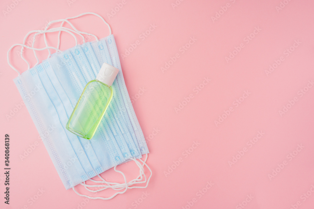 Coronavirus concept. Pandemic of coronavirus. Protective medicine mask, and antibacterial gel on pink background. Coronavirus concept. Pandemic of coronavirus. Protective medicine mask, and antibacterial gel on pink background.