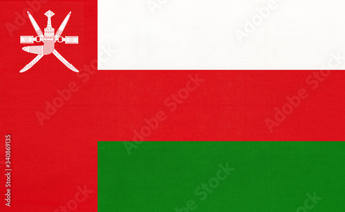 Sultanate of Oman national fabric flag, textile background. Symbol of international asian arabian world country.