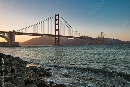 Beautiful view of famous Golden Gate Bridge in San Francisco in the rays of the setting sun photo