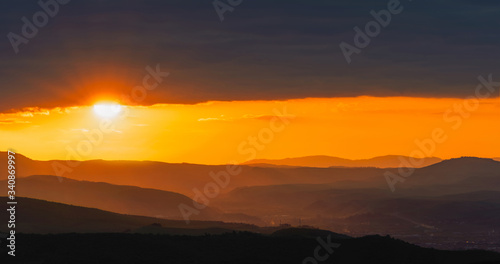 sunset in the mountains over town in the valley   © b. Sergiu