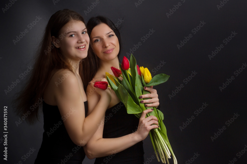 Portrait of girl and woman with tulips in the Studio Portrait of girl and woman with tulips in the Studio