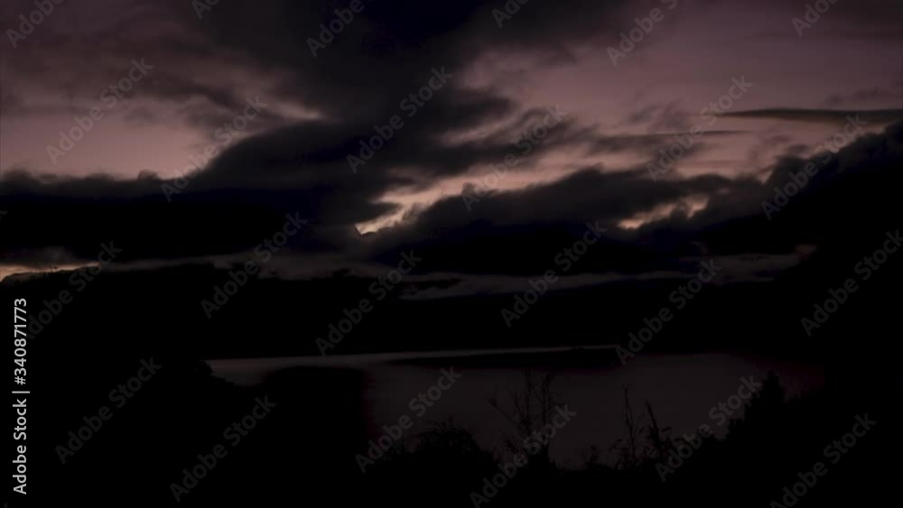 Sunrise over water through the clouds in Queenstown, New Zealand, Time lapse Sunrise over water through the clouds in Queenstown, New Zealand, Time lapse