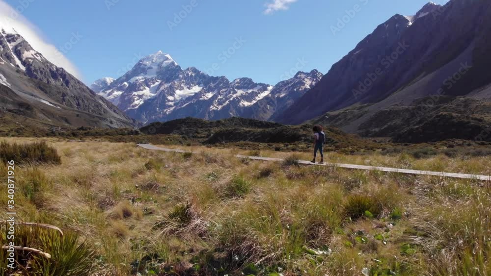 Adult Female Walking Wooden Hooker Valley Track Trail on Clear Day, Aerial Adult Female Walking Wooden Hooker Valley Track Trail on Clear Day, Aerial
