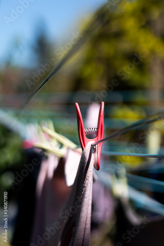 Laundry out to dry pegged to a rotary airer on a warm sunny spring day with sallow depth of field photo