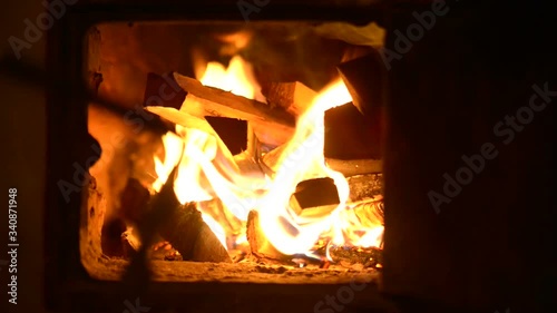 The old village in the Russian province. Firewood burns hot in a rustic stove.