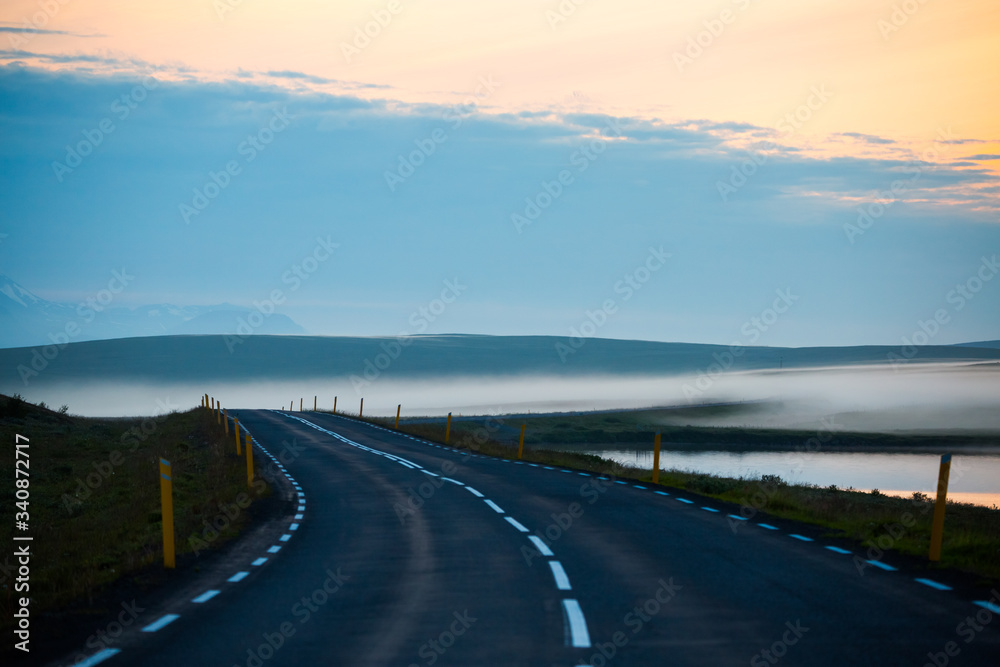 Beautifull view of road with foggy and masvatn lake at morning. this lake is close to Myvatn lake in the highly volcanic region of north iceland.