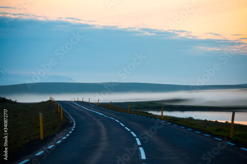 Beautifull view of road with foggy and masvatn lake at morning. this lake is close to Myvatn lake in the highly volcanic region of north iceland.