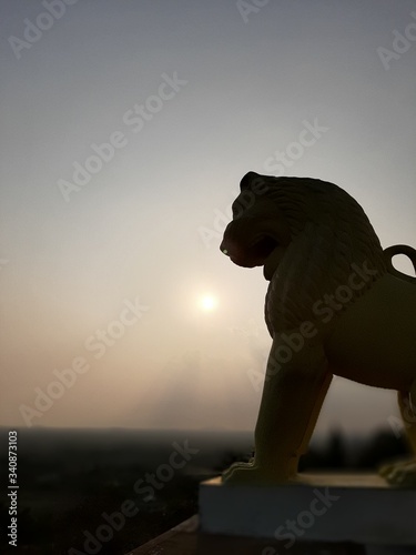 lion statue at sunset