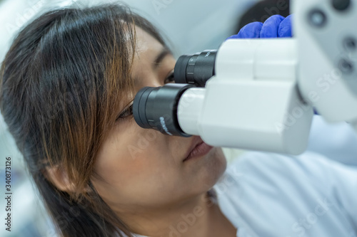 Picture of scientist using a microscope in a laboratory, Concept science and Technology, Science background