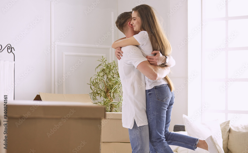 Lovely couple dancing in new empty flat