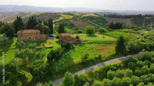Aerial flyover the beautiful sunset landscape in Tuscany, Italy.