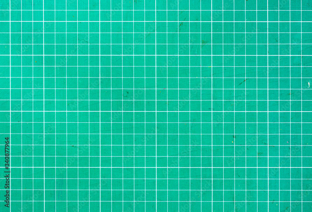 Plastic green cutting mat texture. squared sheet texture green background Plastic green cutting mat texture. squared sheet texture green background