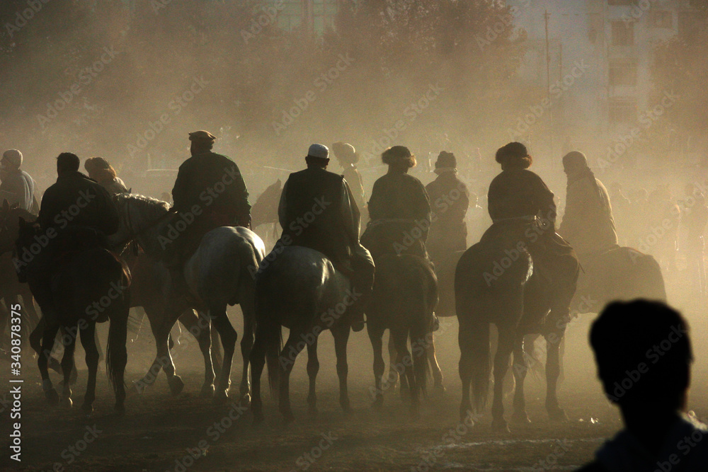Boskachi horse riders in dust cloud